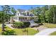 Charming two-story home with a welcoming front porch and beautiful landscaping on a well maintained lawn at 8970 Palmetto Rd, Edisto Island, SC 29438