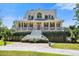 Charming home with a welcoming porch, beautiful landscaping, and a vibrant red front door at 8970 Palmetto Rd, Edisto Island, SC 29438