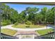 Scenic view from porch of a circular driveway, showcasing lush greenery and a well-maintained landscape at 8970 Palmetto Rd, Edisto Island, SC 29438
