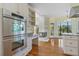 Bright kitchen with stainless steel appliances, wooden floors and marble countertops at 8970 Palmetto Rd, Edisto Island, SC 29438