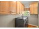 Well-equipped laundry room featuring washer, dryer, and cabinets for storage and organization at 8970 Palmetto Rd, Edisto Island, SC 29438