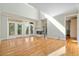 Bright living room featuring a fireplace, high ceilings and gleaming hardwood floors and access to the outdoor porch at 8970 Palmetto Rd, Edisto Island, SC 29438