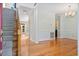Open-concept living space with hardwood floors, staircase, and modern chandelier at 8970 Palmetto Rd, Edisto Island, SC 29438