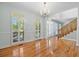 Elegant living room with hardwood floors, white trim, and abundant natural light at 8970 Palmetto Rd, Edisto Island, SC 29438