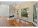 Bright living room featuring a fireplace, wooden floors, and access to a covered porch at 8970 Palmetto Rd, Edisto Island, SC 29438