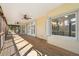 The large screened in porch features wood floors, ceiling fans and multiple access points into the home at 8970 Palmetto Rd, Edisto Island, SC 29438