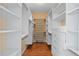 Spacious walk-in closet with custom white shelving and drawers for optimal storage at 8970 Palmetto Rd, Edisto Island, SC 29438