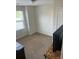 A simple bedroom with neutral carpet and a view out of the window at 9217 Southern Oak Ln, Ladson, SC 29456
