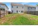 View of the home's backyard featuring green grass and wooden fence at 9923 Honeylocust Ln, Ladson, SC 29456