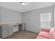 Bedroom featuring a built-in desk with cabinets, gray paint, and pink couch at 9923 Honeylocust Ln, Ladson, SC 29456