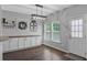 Cozy dining area with hardwood floors, modern lighting, and built-in cabinets, perfect for Gathering meals at 9923 Honeylocust Ln, Ladson, SC 29456