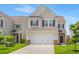 Charming two-story home featuring a two-car garage, well-manicured lawn, and inviting curb appeal at 9923 Honeylocust Ln, Ladson, SC 29456