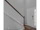 Bright entryway featuring a staircase with wooden accents and a white door, offering a fresh welcome at 9923 Honeylocust Ln, Ladson, SC 29456