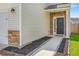 Inviting front entry showcasing stone accents, a sleek black door, and manicured landscaping at 9923 Honeylocust Ln, Ladson, SC 29456