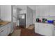 Bright kitchen with stainless steel refrigerator, white cabinets, granite countertops, and hardwood floors at 9923 Honeylocust Ln, Ladson, SC 29456