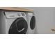 Laundry room with white front load washer and dryer and a shelf above at 9923 Honeylocust Ln, Ladson, SC 29456