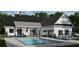 Backyard view showcasing a luxurious pool, outdoor lounge area, and stylish white exterior of the home at 0 Faulkner Dr, Mount Pleasant, SC 29466