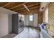 Unfinished basement area with brick walls, stainless refrigerator, shelving, and exterior door at 1010 Fiall St, Charleston, SC 29407