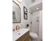 Bathroom featuring modern fixtures, a gold-trimmed mirror, and a walk-in shower with gold hardware at 1010 Fiall St, Charleston, SC 29407