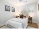 Bright bedroom with a patterned headboard, white bedding, wooden nightstands, and tasteful decor at 1010 Fiall St, Charleston, SC 29407