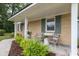 Charming front porch with brick facade, manicured landscaping, and comfortable seating at 1010 Fiall St, Charleston, SC 29407