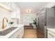 Well-lit kitchen featuring stainless steel appliances, white cabinets, and a functional layout for cooking and dining at 1010 Fiall St, Charleston, SC 29407