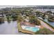 Aerial view of community pool and tennis courts surrounded by lake, houses, and lush greenery at 1027 Wayfarer Ln, Charleston, SC 29412