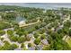 Beautiful aerial view of the community with winding roads, lush landscaping, and a pool by a pond at 1027 Wayfarer Ln, Charleston, SC 29412