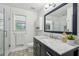 Stylish bathroom with a patterned tile floor, marble countertop and a glass shower at 1027 Wayfarer Ln, Charleston, SC 29412