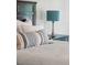 Bedroom detail shows stylishly decorated bed and bedside table with lamp at 1027 Wayfarer Ln, Charleston, SC 29412