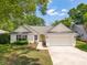 Beautiful home with a welcoming bright yellow front door, well-kept lawn, and an attached two-car garage at 1027 Wayfarer Ln, Charleston, SC 29412