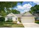 Attractive single-story home featuring a bright yellow front door, white siding, attached garage, and well-manicured lawn at 1027 Wayfarer Ln, Charleston, SC 29412