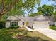 Inviting single-Gathering home with a bright yellow front door, attached garage, and lush green lawn at 1027 Wayfarer Ln, Charleston, SC 29412