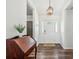 Warm foyer with wood floors, decorative wainscoting, a charming desk, and an attractive light fixture at 1027 Wayfarer Ln, Charleston, SC 29412