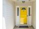 Close-up of a bright yellow front door with decorative glass and sidelights, adding charm and curb appeal to the home at 1027 Wayfarer Ln, Charleston, SC 29412