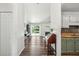 Inviting interior view of the home showcasing wood floors, a fireplace, kitchen, and sliding glass doors to the backyard at 1027 Wayfarer Ln, Charleston, SC 29412
