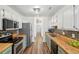 Bright, modern kitchen features stainless appliances, butcher block countertops, and attractive flooring at 1027 Wayfarer Ln, Charleston, SC 29412