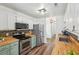 Well-lit kitchen features butcher block countertops, stainless steel appliances, and tiled backsplash at 1027 Wayfarer Ln, Charleston, SC 29412