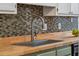 Kitchen sink features a stainless steel sink, wooden countertops and tiled backsplash at 1027 Wayfarer Ln, Charleston, SC 29412