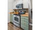 Modern kitchen with stainless steel appliances, light green cabinets and wooden countertops at 1027 Wayfarer Ln, Charleston, SC 29412