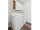 Laundry room features white washer and dryer with overhead cabinets for storage at 1027 Wayfarer Ln, Charleston, SC 29412