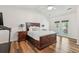 Spacious bedroom features a large bed, wood floors, ceiling fan, and access to balcony at 1027 Wayfarer Ln, Charleston, SC 29412