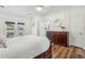 Bright bedroom features wood floors, a ceiling fan, dresser and access to en suite bathroom at 1027 Wayfarer Ln, Charleston, SC 29412