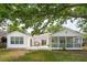 Back exterior showcasing a deck, screened porch, and lake views, perfect for enjoying the outdoor space at 1027 Wayfarer Ln, Charleston, SC 29412