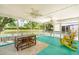 Relaxing screened porch with lake views, featuring a ceiling fan and comfortable seating for enjoying the outdoors at 1027 Wayfarer Ln, Charleston, SC 29412