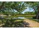 Tranquil lake view from the property, featuring a dock and lush greenery along the shoreline at 1027 Wayfarer Ln, Charleston, SC 29412