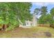 Backyard features a well-kept lawn, privacy fence, and mature trees surrounding the home at 1042 Cobblestone Blvd, Summerville, SC 29486