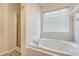 Bright bathroom featuring a soaking tub with chrome fixtures and a separate shower at 1042 Cobblestone Blvd, Summerville, SC 29486