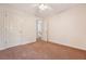 Bedroom with neutral walls, carpet flooring, ceiling fan, and two doors at 1042 Cobblestone Blvd, Summerville, SC 29486