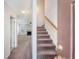 Inviting entryway with view to the carpeted living room with fireplace and staircase leading to the upper level at 1042 Cobblestone Blvd, Summerville, SC 29486